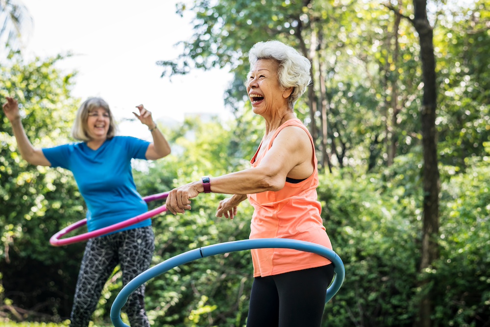 Two senior women exercising outside at the senior living in Palm Springs