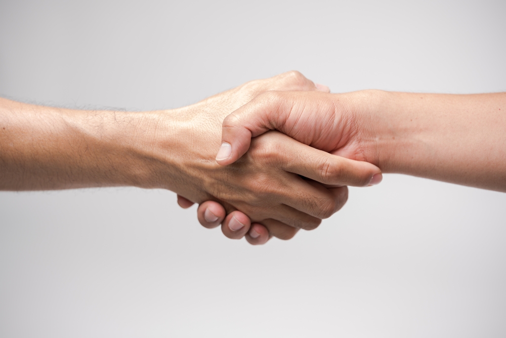 Two people shaking hands in memory care in Yorba Linda.