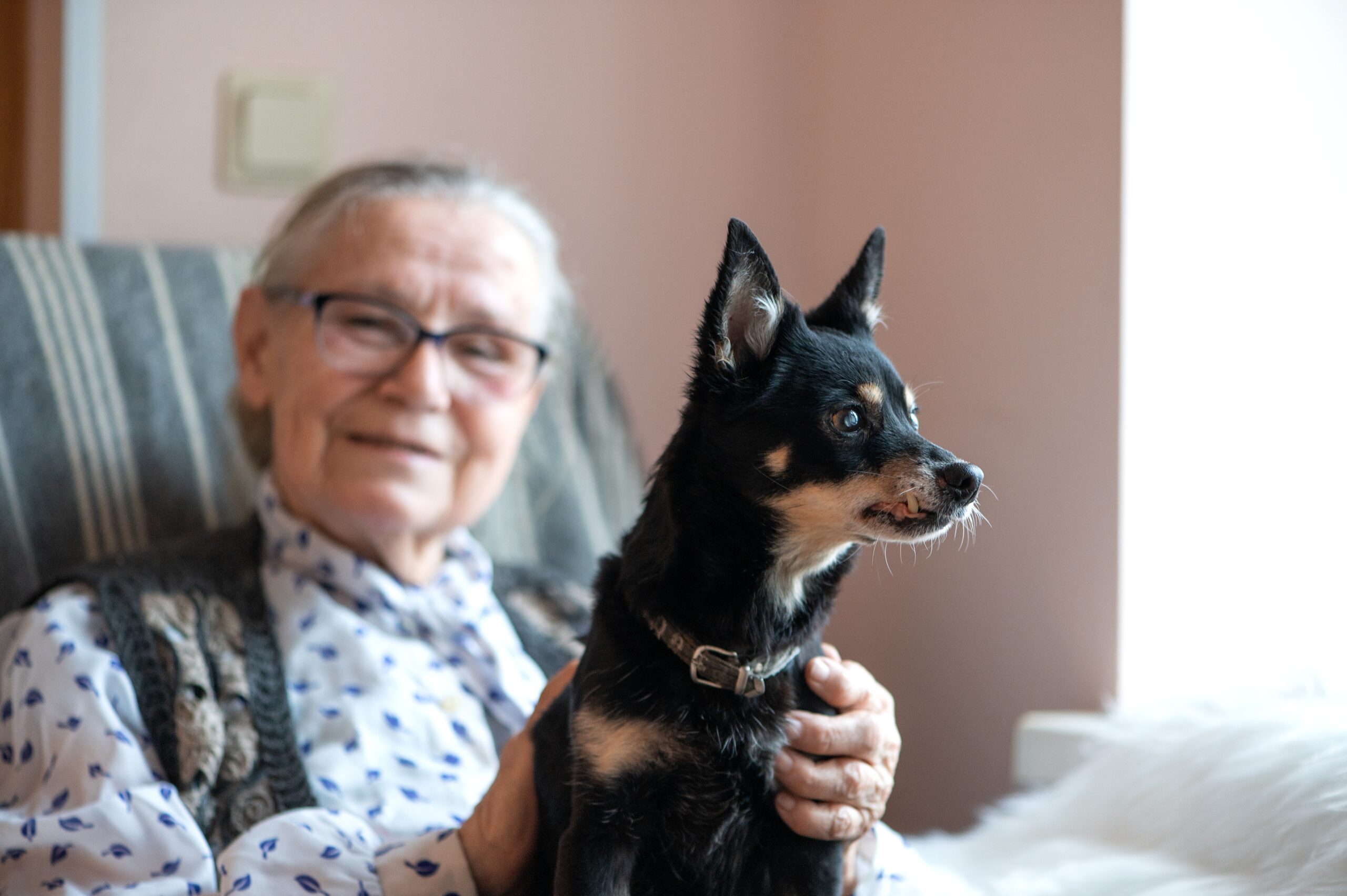 Woman with dog in assisted living in Yorba Linda, CA.