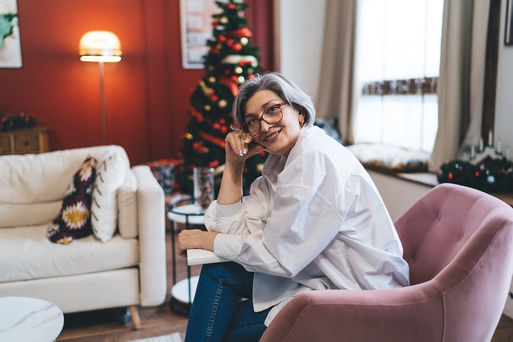 A woman enjoying her assisted living apartment decorated for the holidays