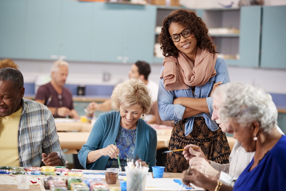 Seniors enjoying group art activity at their Memory care apartments