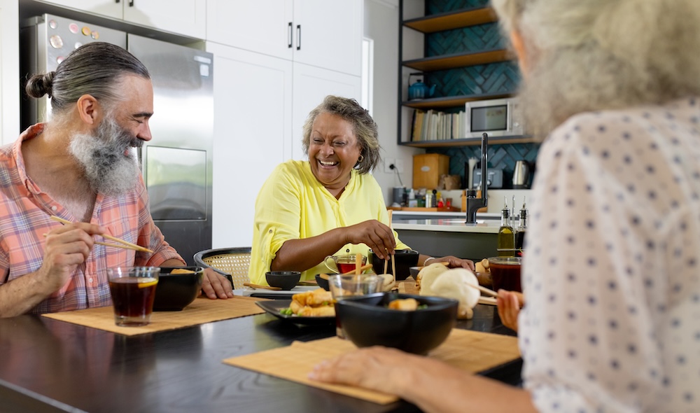 Group of seniors enjoying their lunch at assisted living apartment floor plans